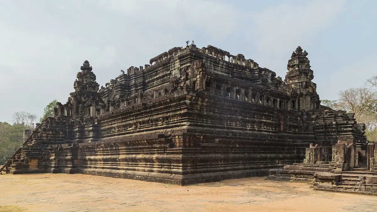 Side view of the stepped Baphuon temple mountain in dry light