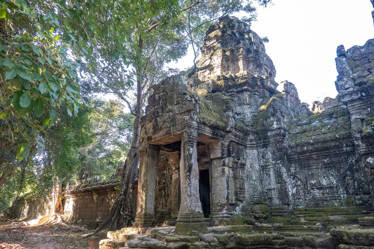 Tower and gate at Preah Khan with tree roots on the stone