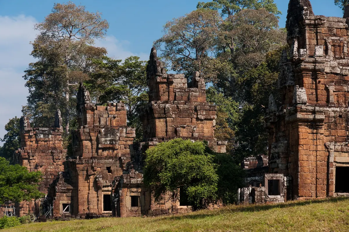 Group of ruined brick towers with small shrubs