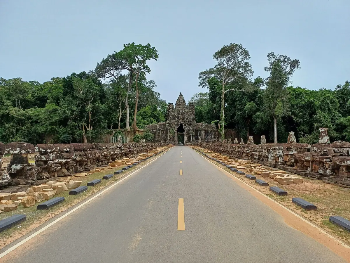 Straight road leading to the Victory Gate through the forest